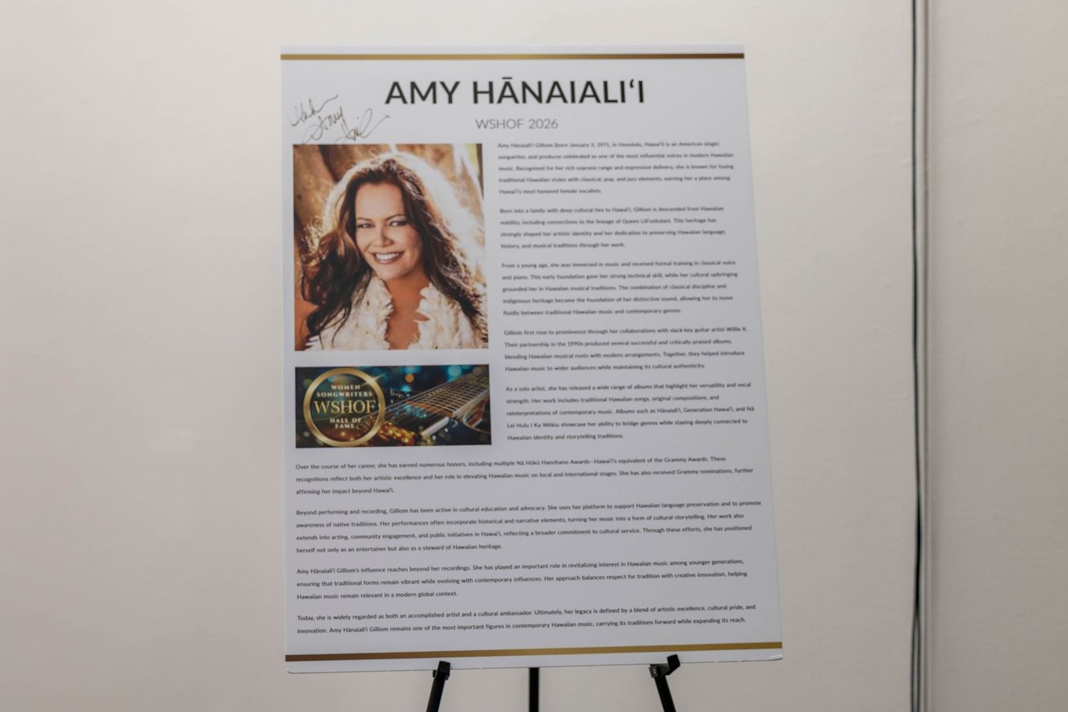Amy Hanaiali'i biography display board on easel with photo and text at an awards or recognition event.