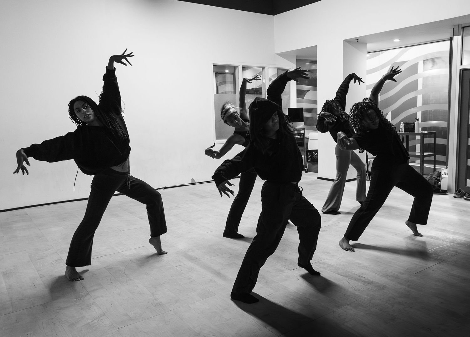 A sequence of dance movements showing a person performing dynamic floor-based choreography in a studio space.