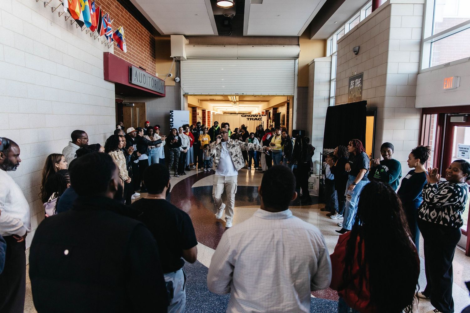 A crowded hallway filled with people at what appears to be a conference or convention center.