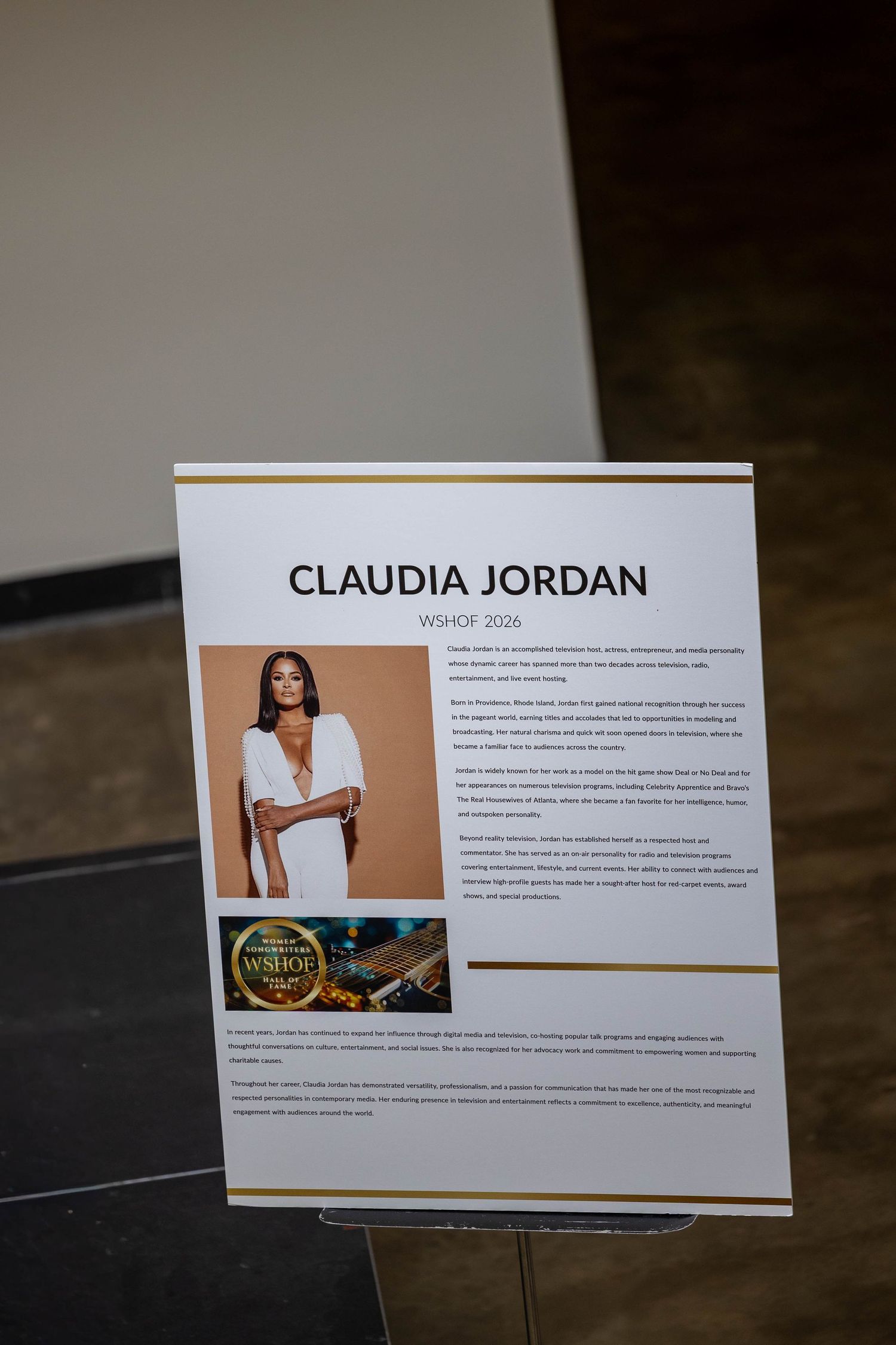 Claudia Jordan VOHOF 2024 inductee award display board with photo and biography at formal ceremony.