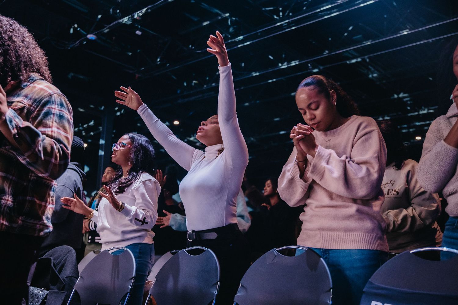 A group of performers singing and dancing on stage during an emotional gospel music performance.