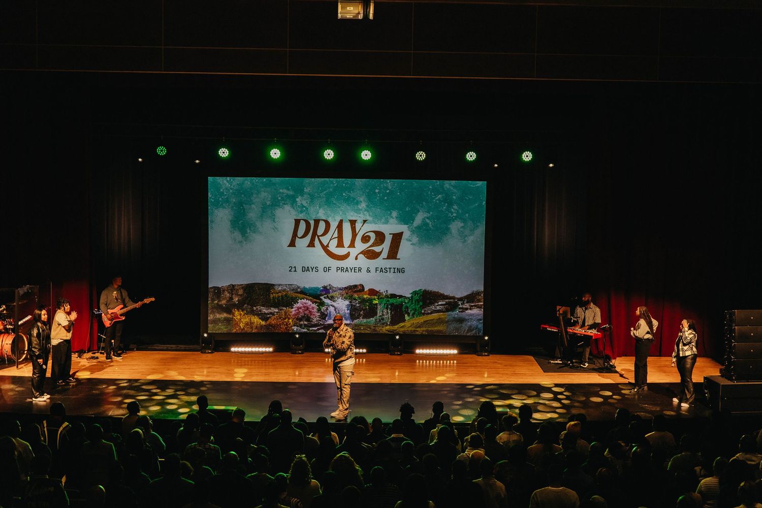 A series of wide stage performance photos showing theatrical lighting and silhouettes against dramatic backdrops.