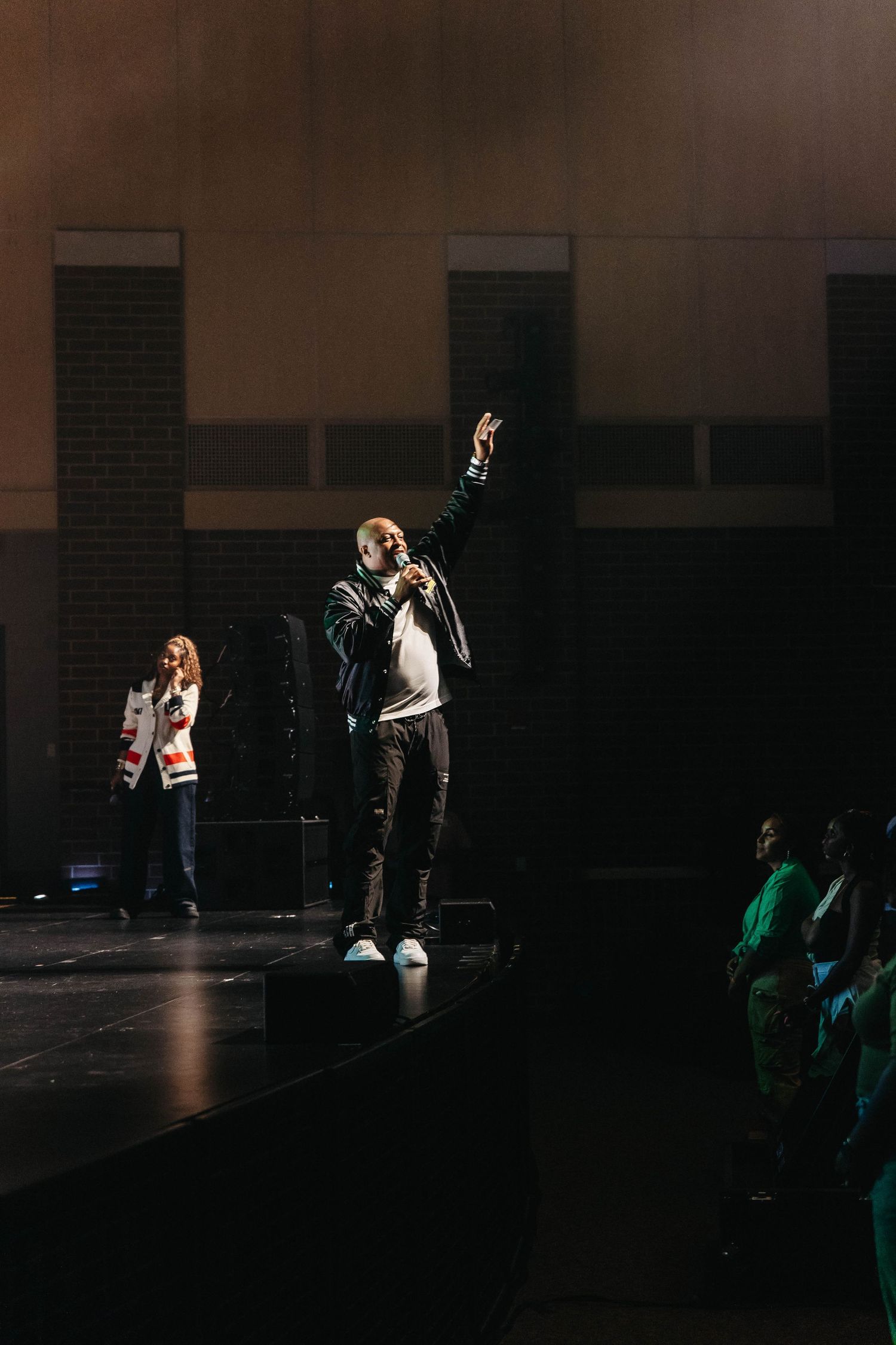 Dramatic stage performance captured in low-light conditions with spotlit performers.