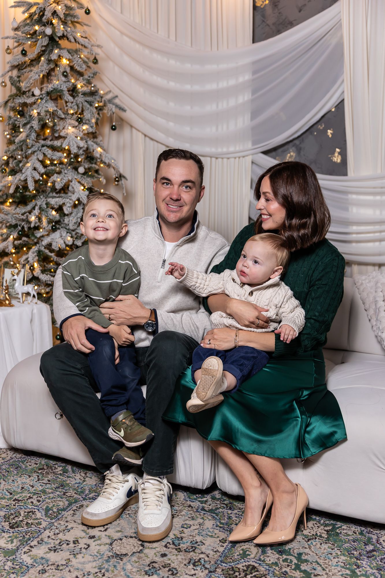arizona Holiday family portrait session with decorated Christmas tree and white backdrop.