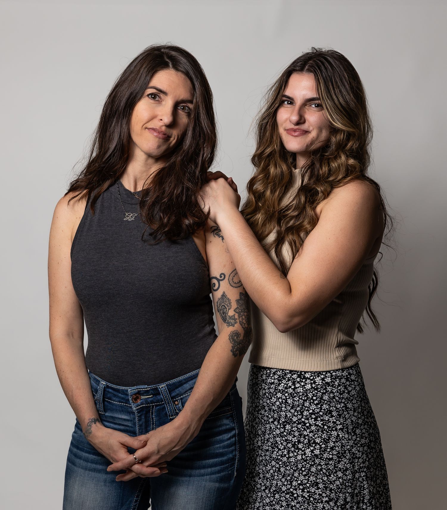 Studio portrait series showing casual poses against a neutral grey background.