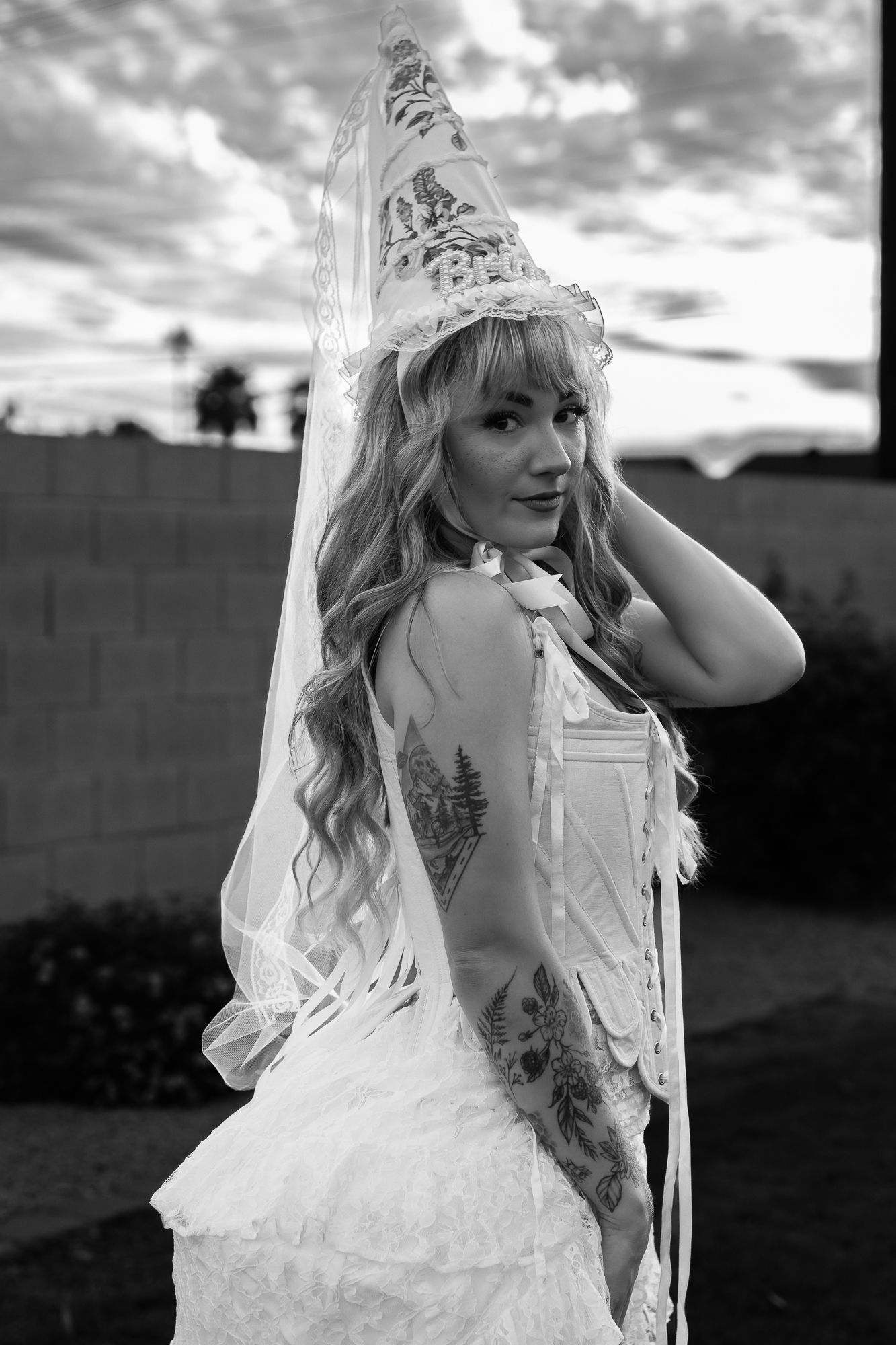 Black and white artistic photos of a person in a white dress and veil posing outdoors at sunset. scottsdale wedding photographer