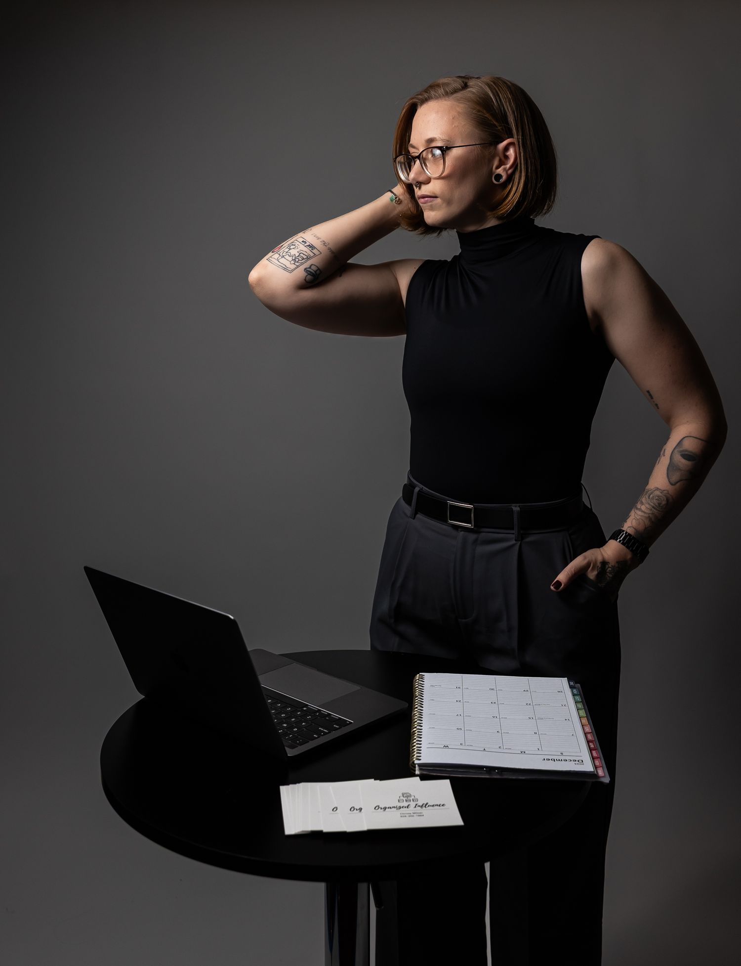 Professional business photoshoot against gray backdrop with laptop and documents. arizona studio