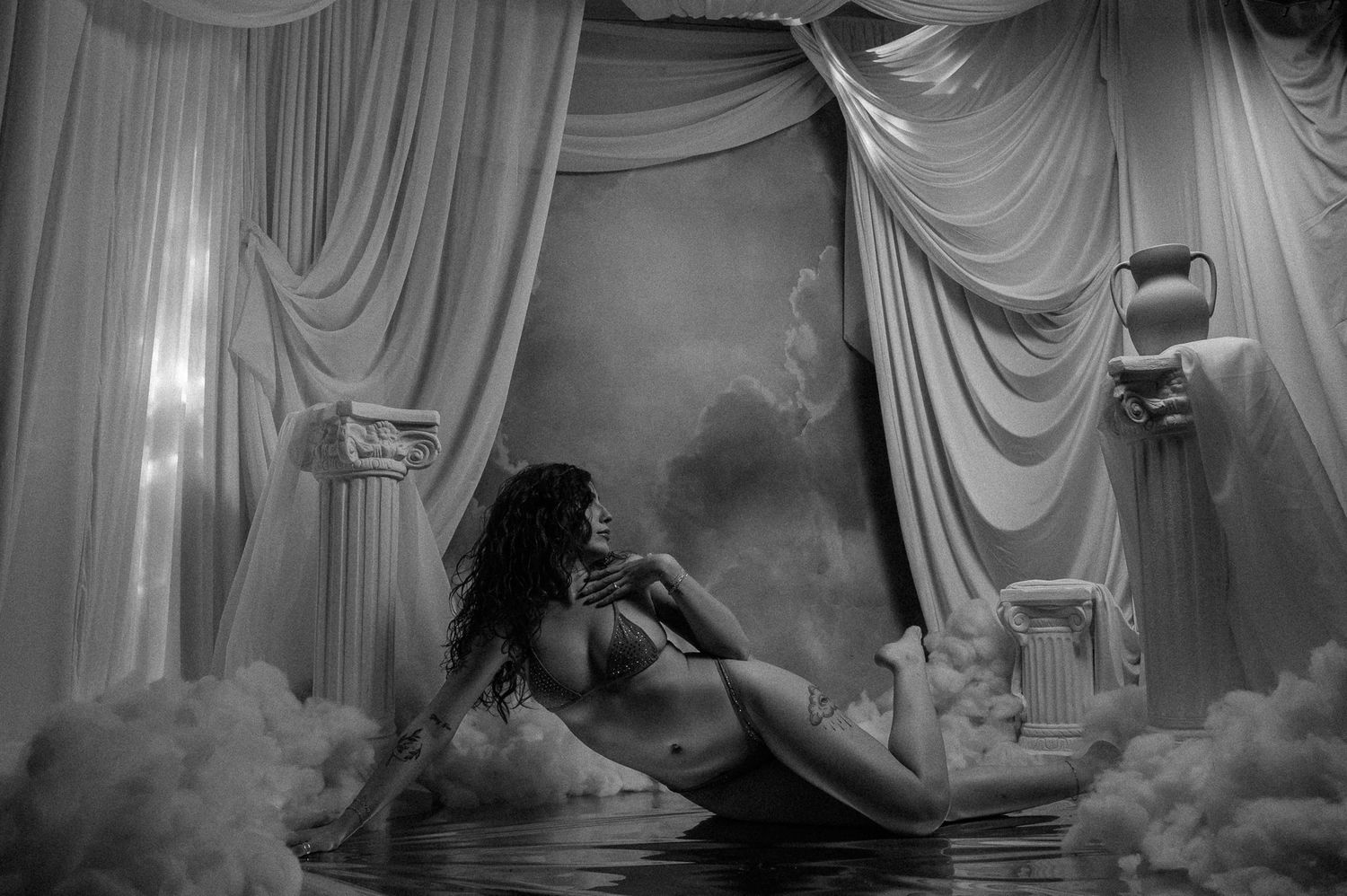 A series of black and white photos showing curtained stage performances with dramatic lighting and smoke effects.