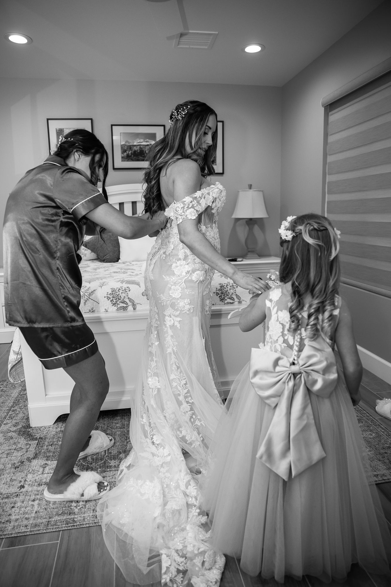 Arizona , scottsdale, Sedona, Black and white photos showing the process of lacing up and adjusting a wedding dress before the ceremony.