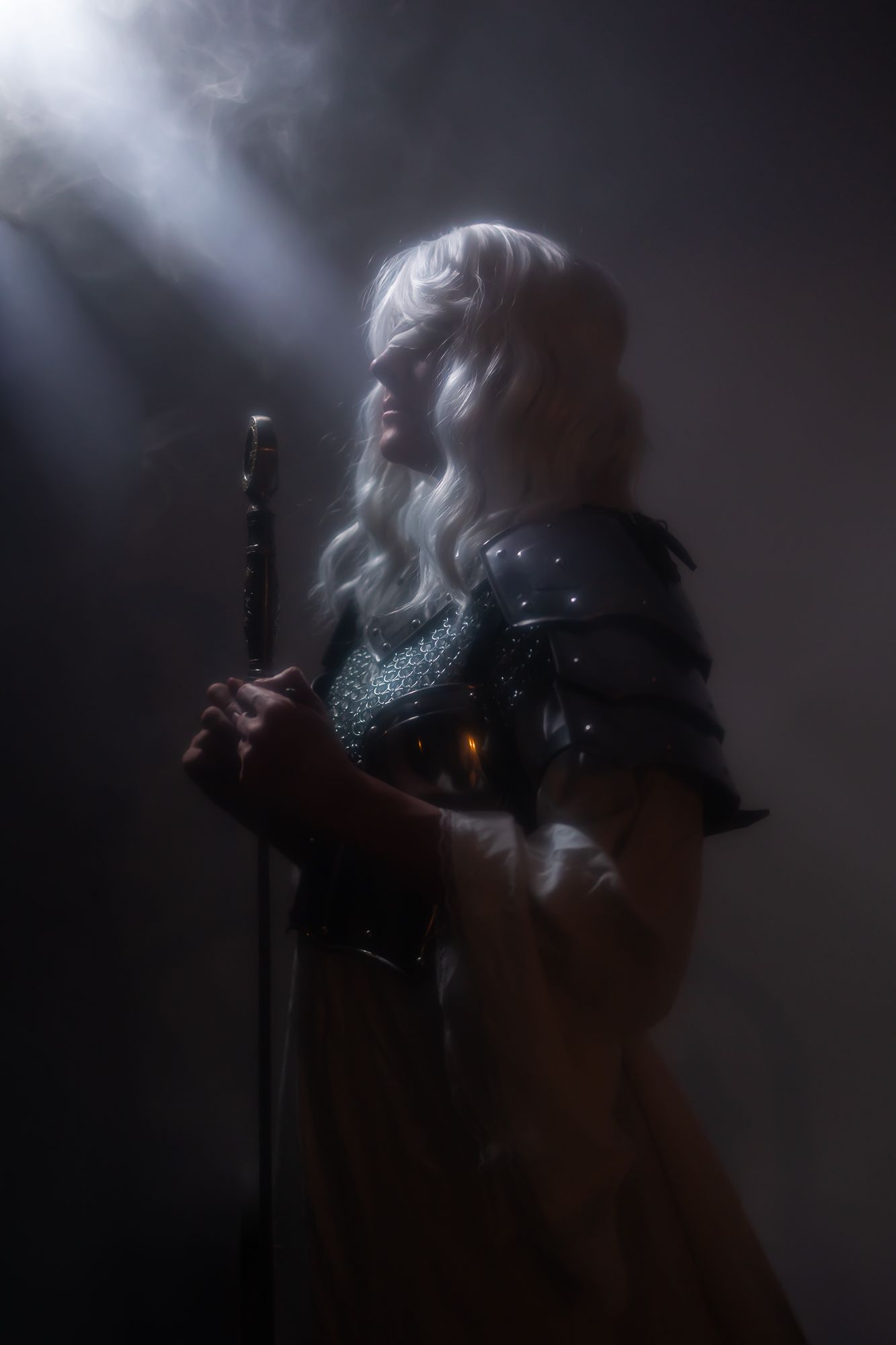 A dramatic silhouette sequence shows a figure in smoky lighting creating ethereal movement against a dark background.