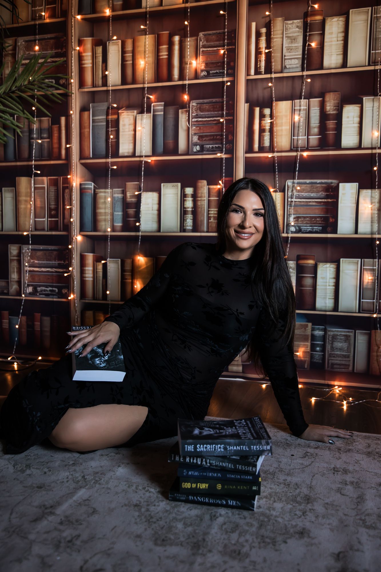 A series of five cozy indoor photos showing someone posing with books in a dimly lit library setting. arizona photography studio