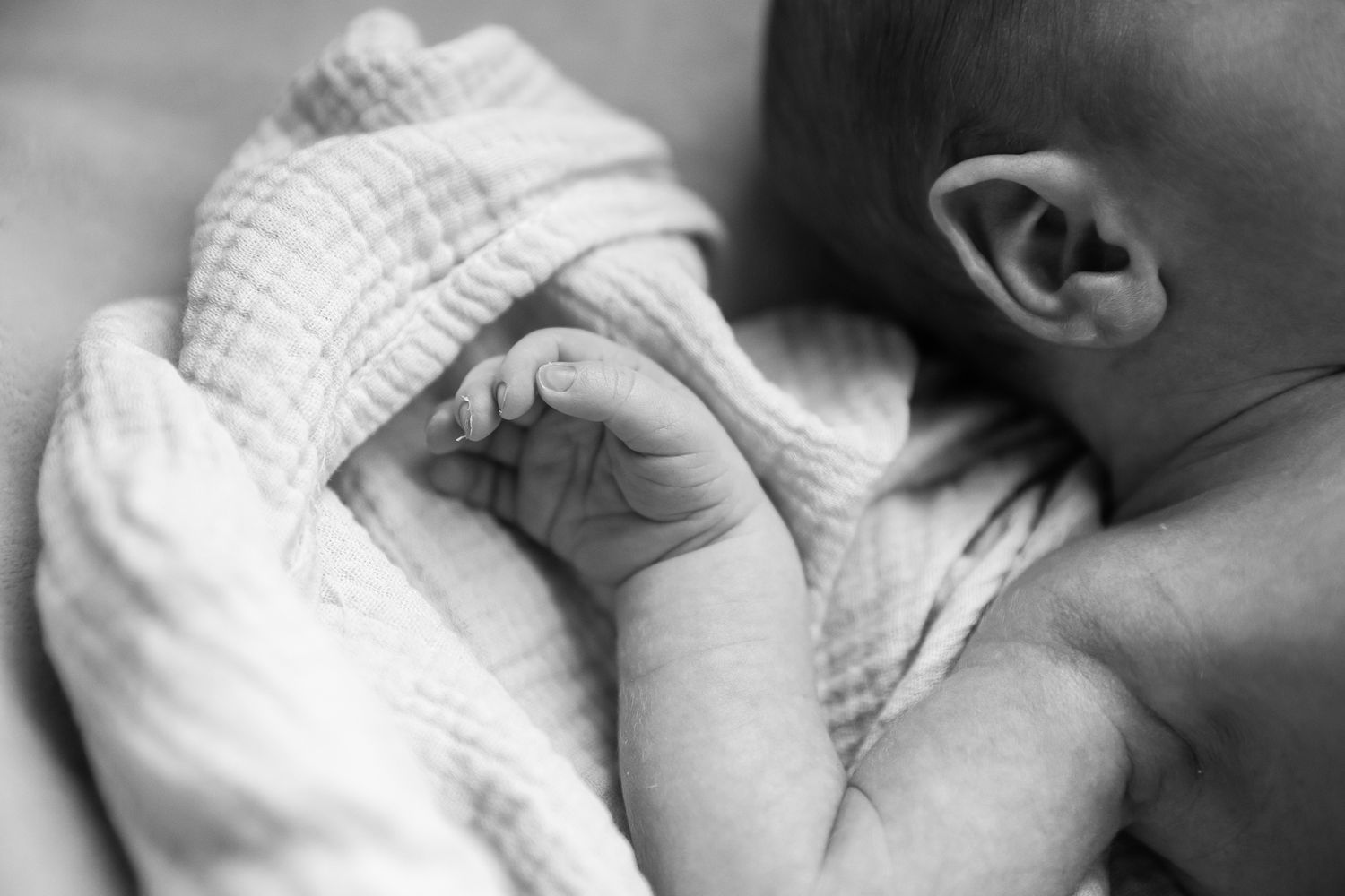 A sequence of black and white photos showing a baby's tiny hand grasping an adult's finger. cottonwood newborn photographer Arizona