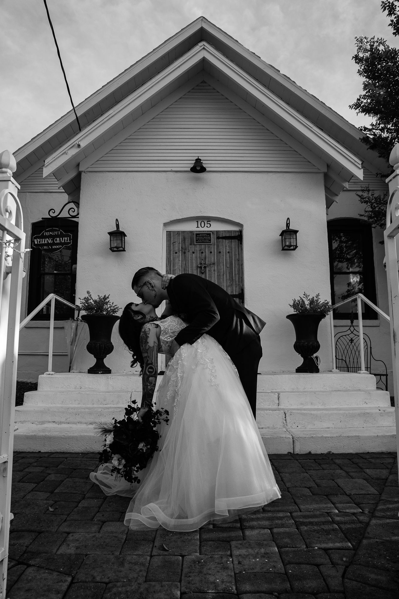 showing a couple dancing and twirling in front of a white porch entrance. Prescott Arizona wedding, Arizona wedding, az wedding photographer