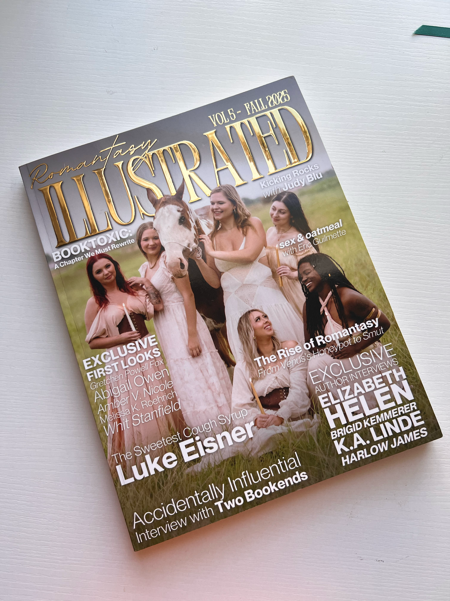 Several glossy magazine covers displayed in a row showing editorial layouts and design on a light background.