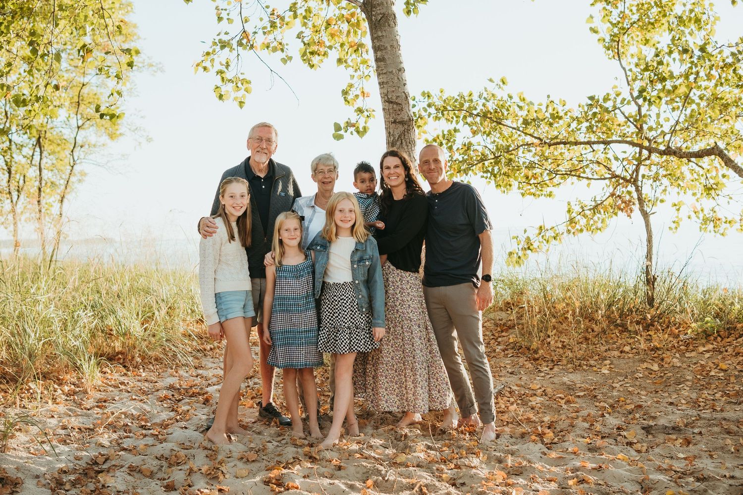 “Multi-generational family smiling together during outdoor session in Northern Michigan”
