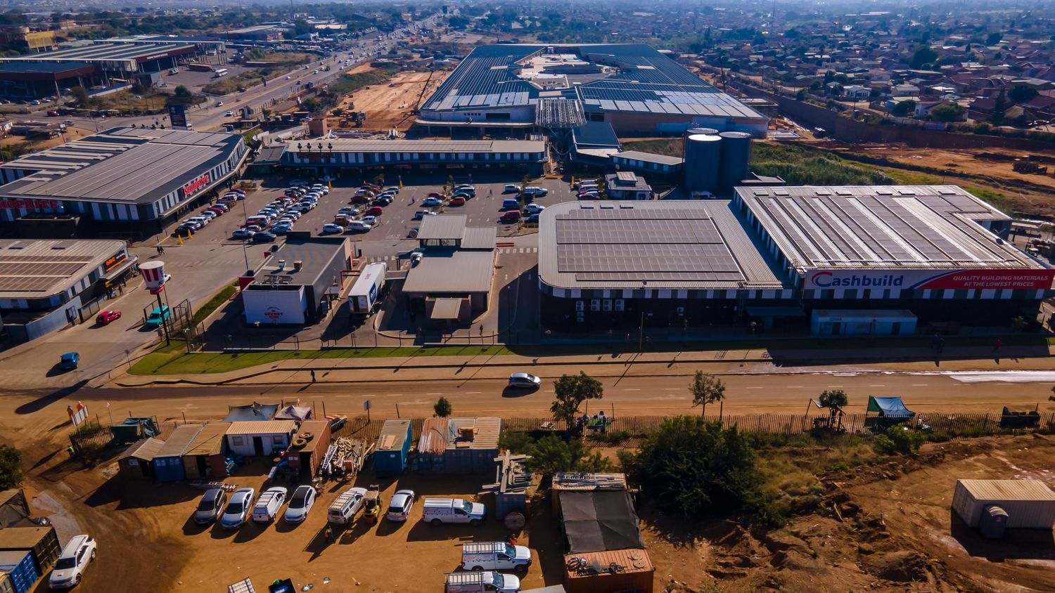 Aerial view of a commercial and industrial district with warehouses and busy roads in an urban area.