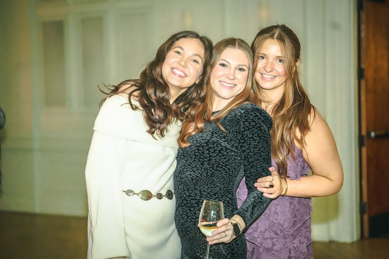 Group celebration photo at formal event with people in elegant attire.
