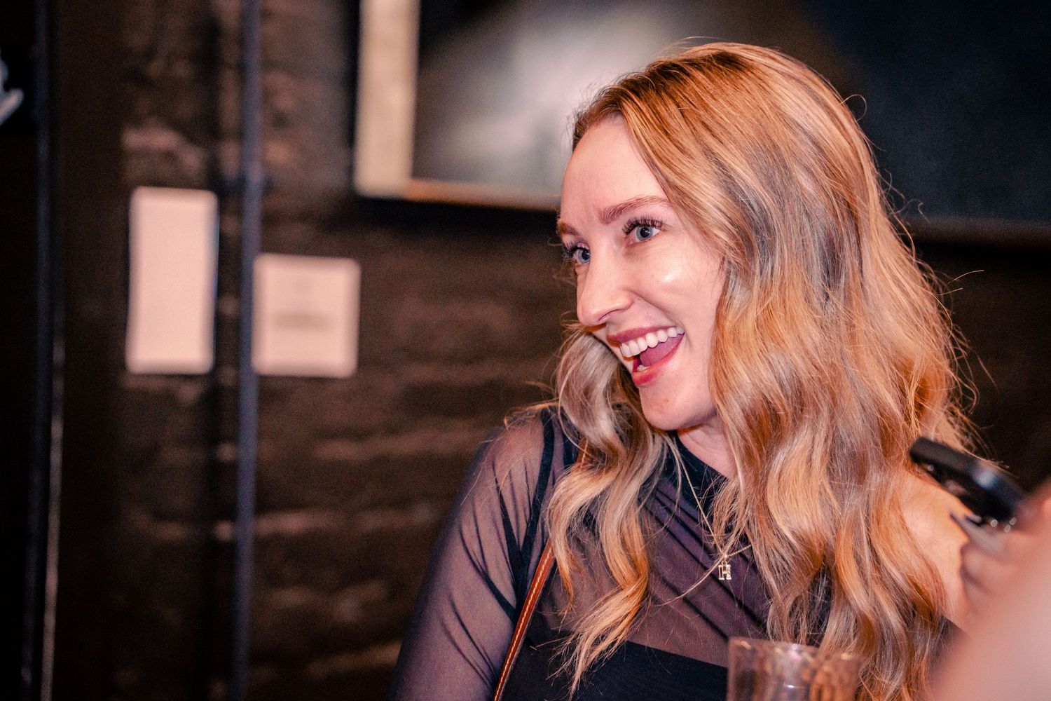 Candid moments captured during an evening social gathering with moody lighting.