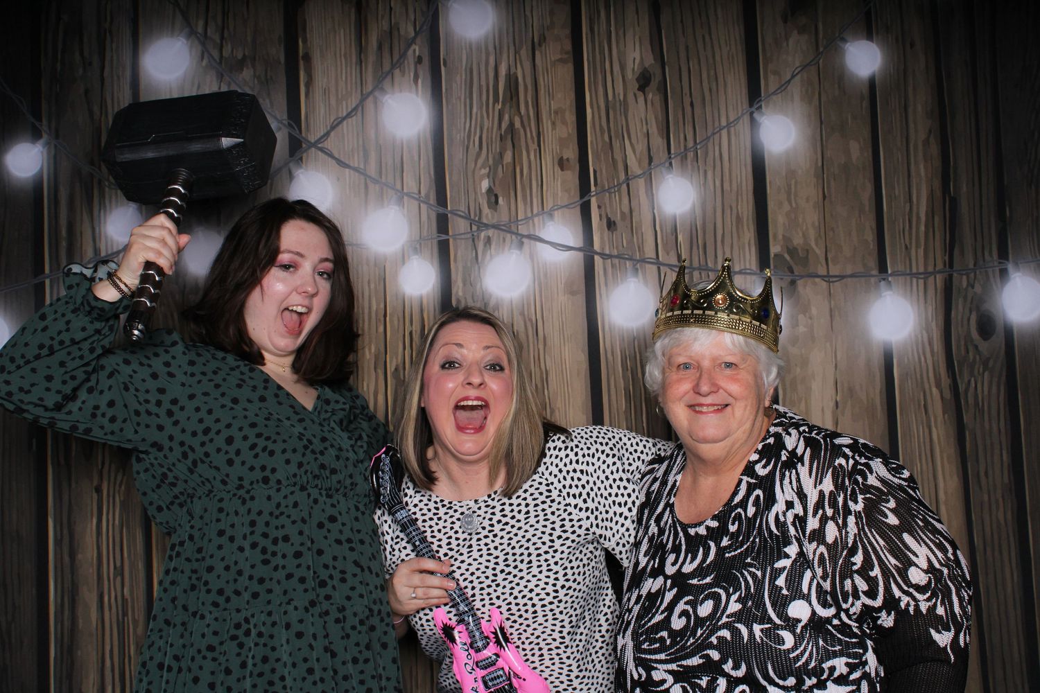 Group photo booth shots with partygoers having fun against rustic wood paneling and string lights.