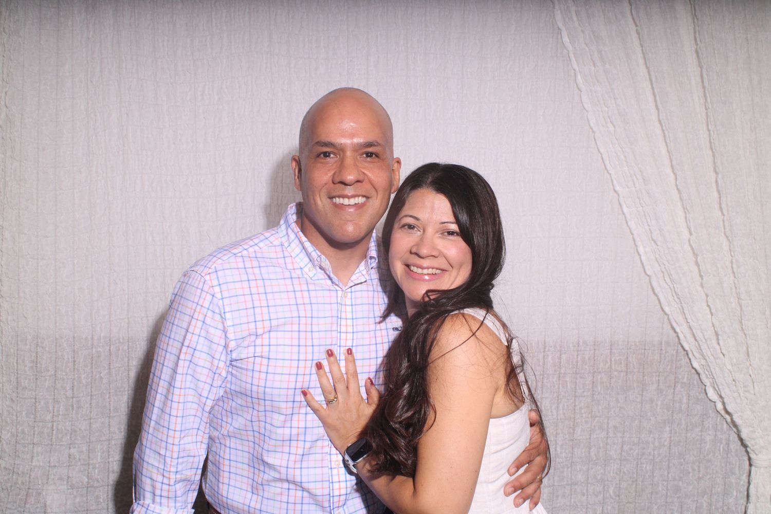 Couple poses together in a series of black and white photo booth style shots showing affection and smiles.