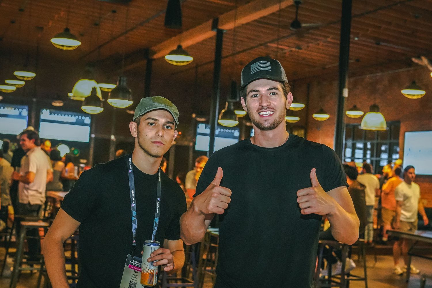 Friends hanging out at a casual bar wearing dark casual attire.