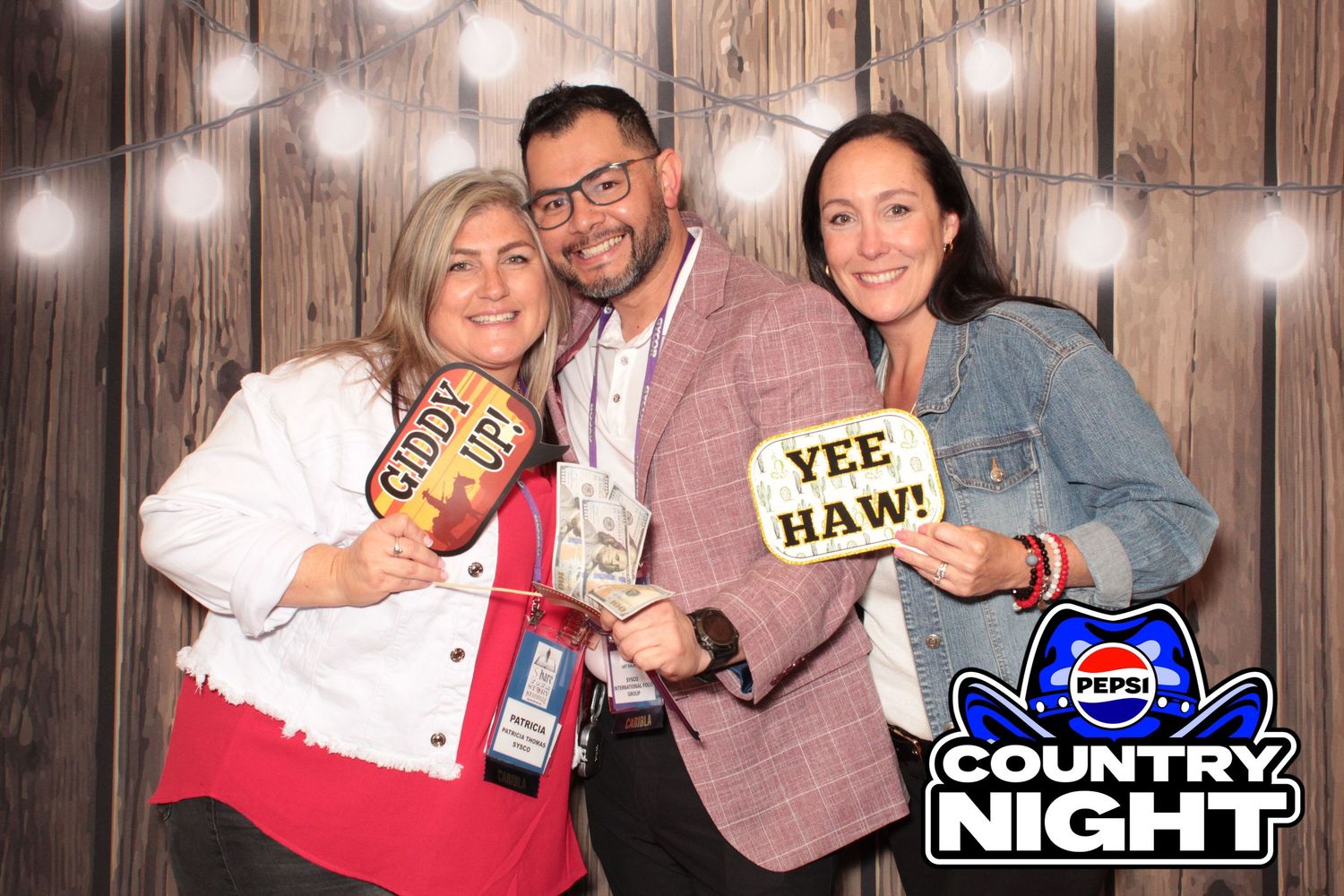 Photo booth strip with rustic wood background and string lights featuring Pepsi Country Night branding.