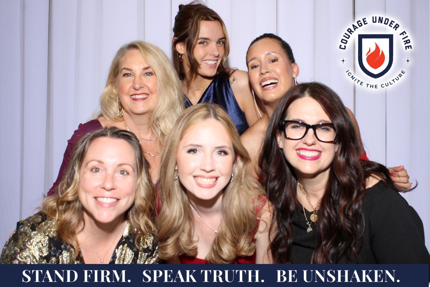 Photo booth strip with multiple shots of people posing together against a white backdrop with company branding.