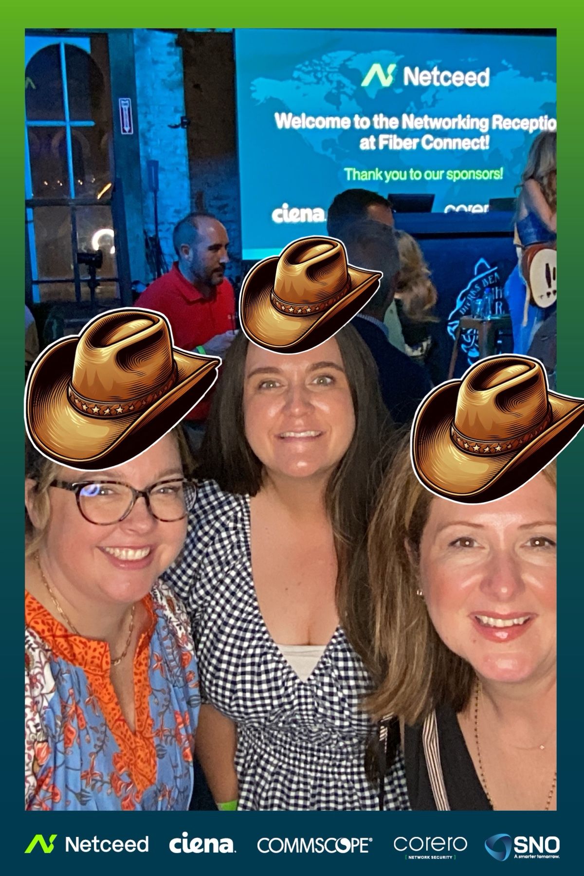 Group photo at networking event with digital cowboy hat filters and company logos in background.