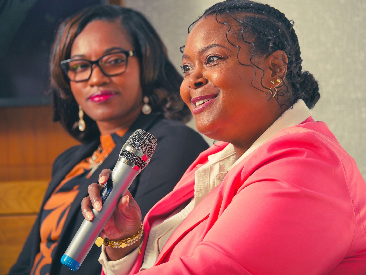 Panel discussion participants seated together at a business conference.