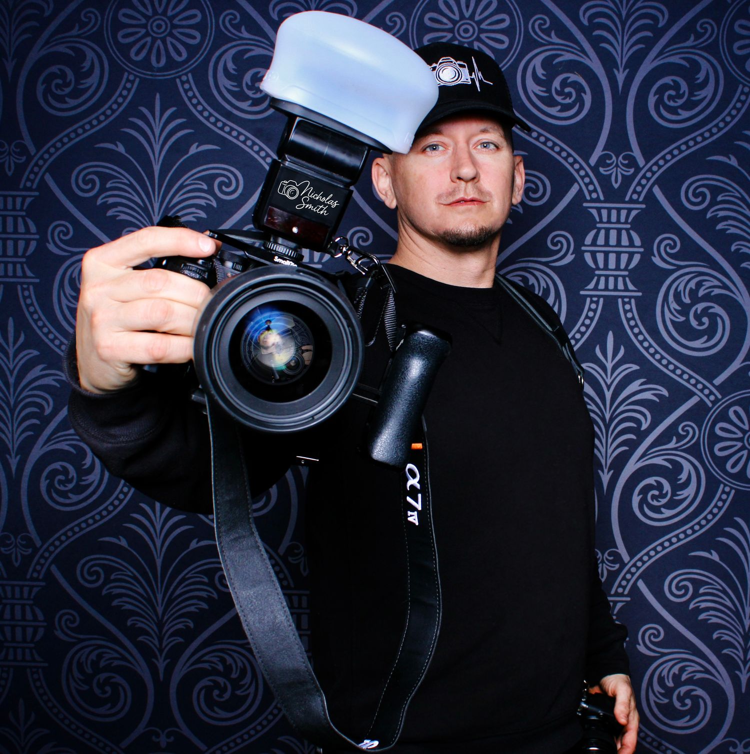Professional photographer holding a camera against a dark patterned background in a series of artistic shots.