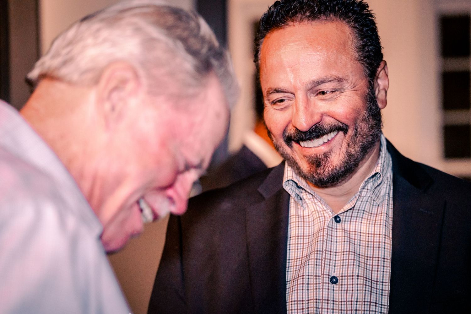Casual conversation between people at a professional networking function.