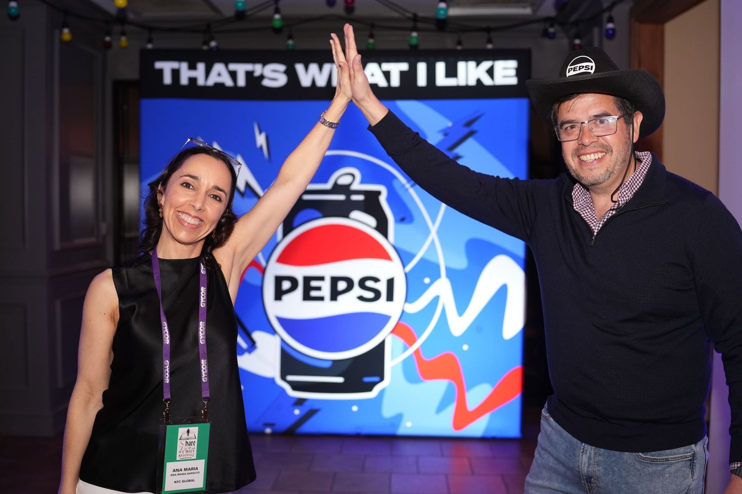 Corporate event with colorful digital displays and branding elements.