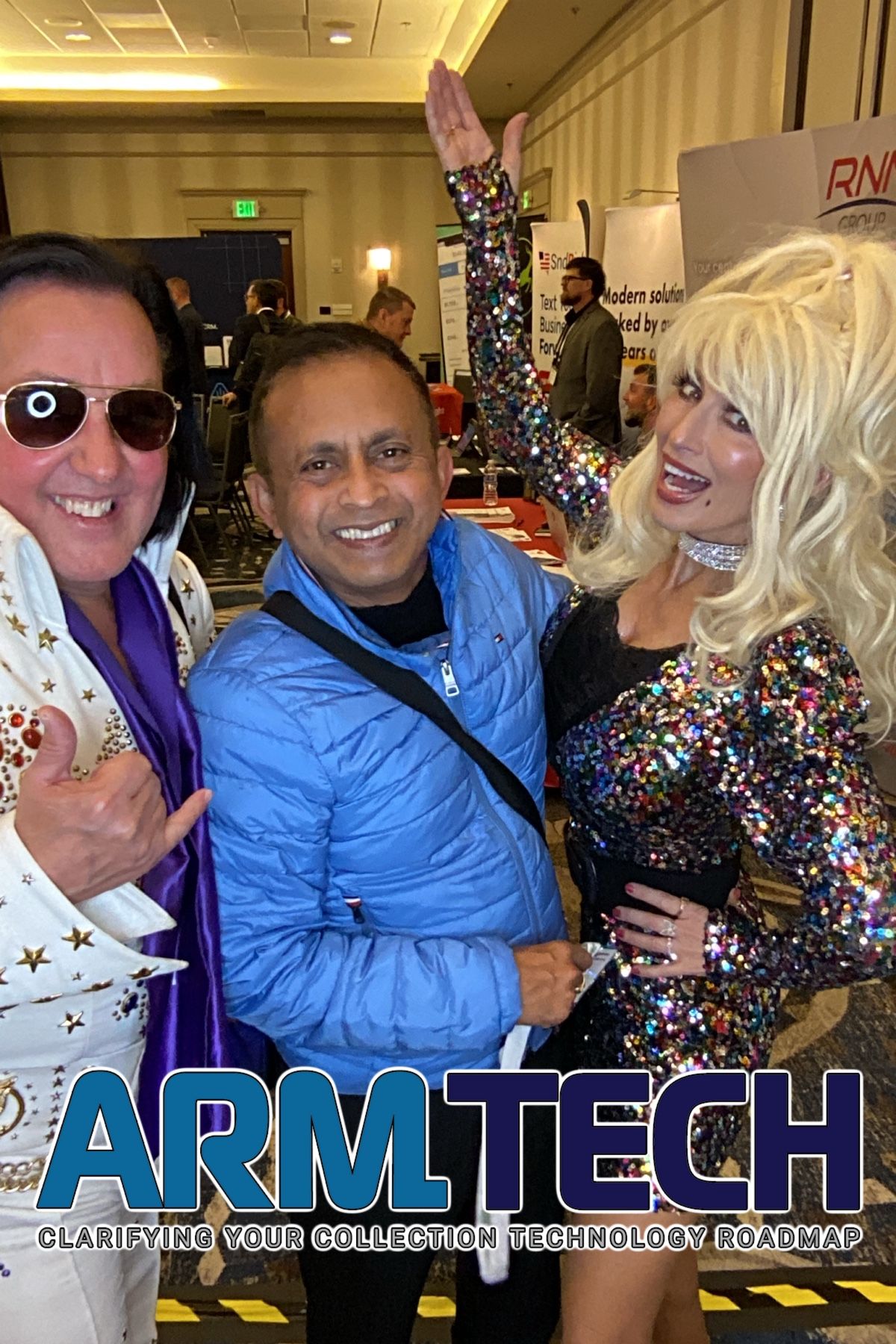People celebrating at tech conference with confetti and APM TECH branding visible in background.