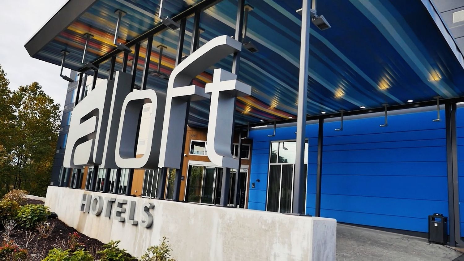 Modern office building exterior with blue architectural details and glass windows.