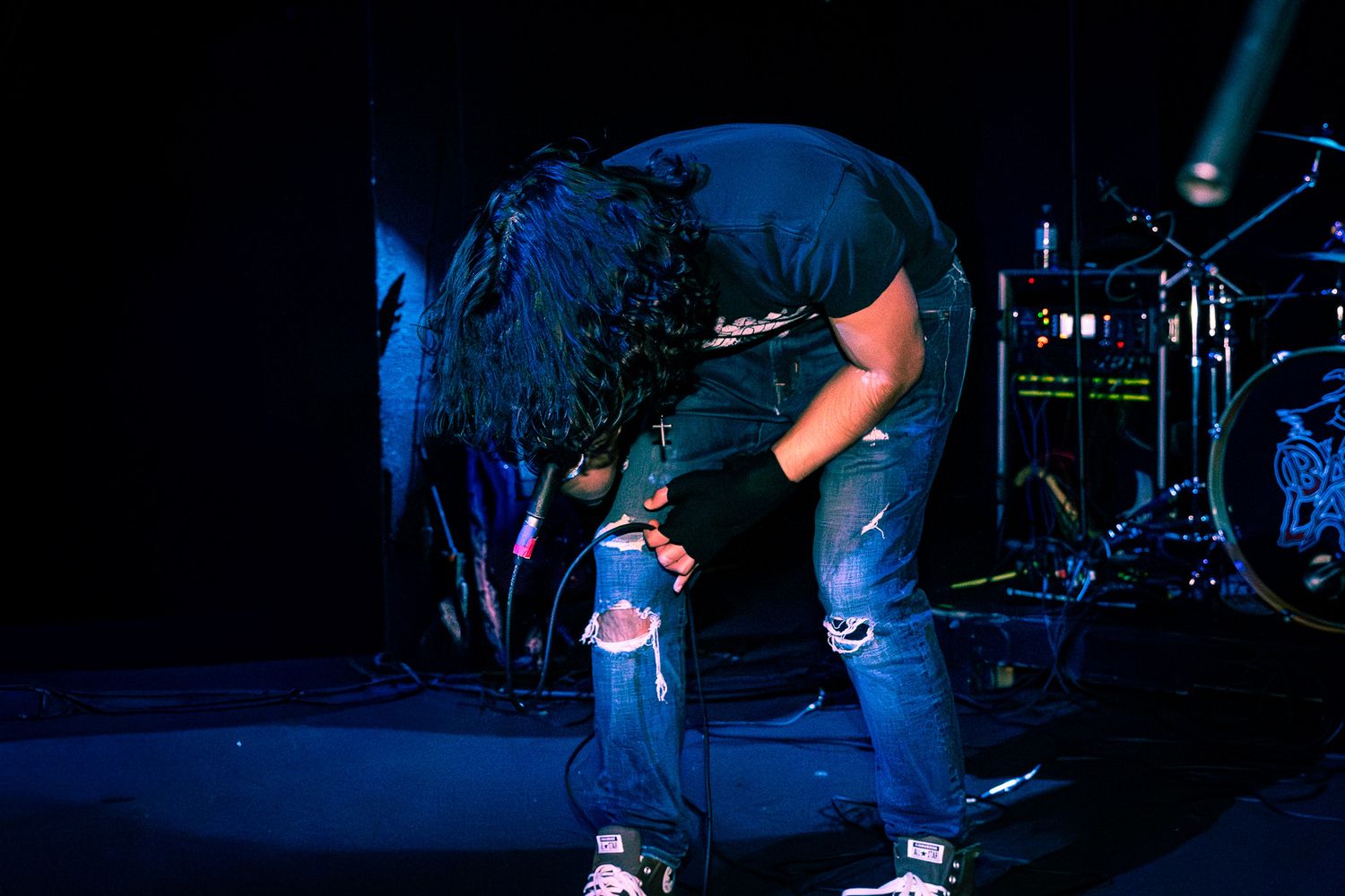 Live concert photography capturing a band performing on stage with dramatic lighting