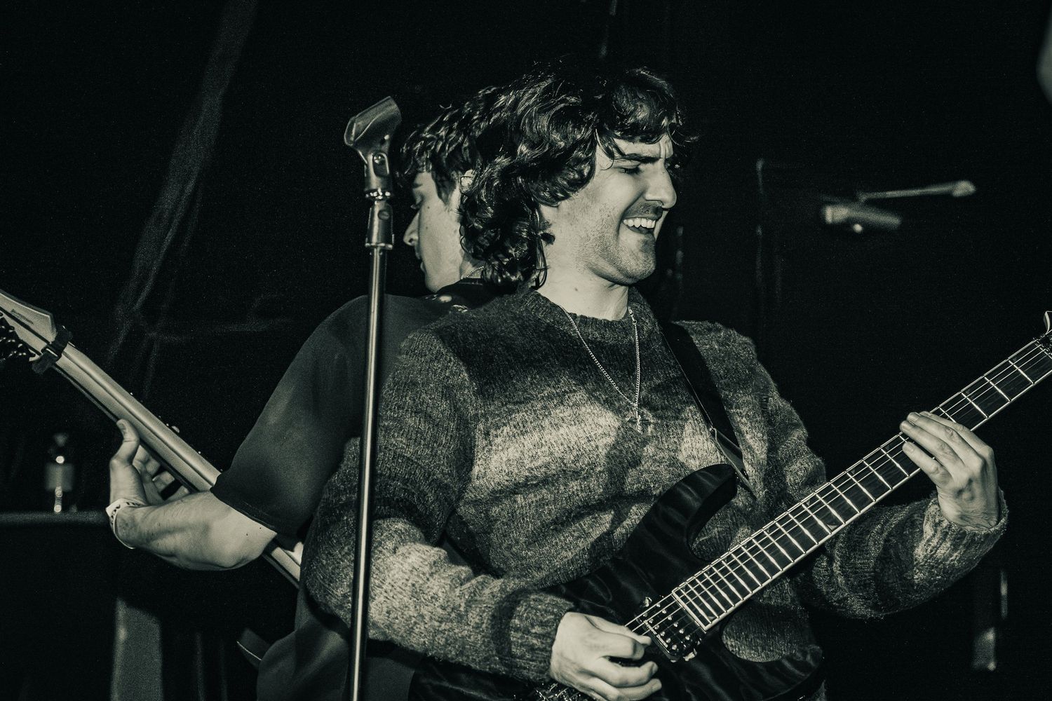 Live concert photography capturing a band performing on stage with dramatic lighting