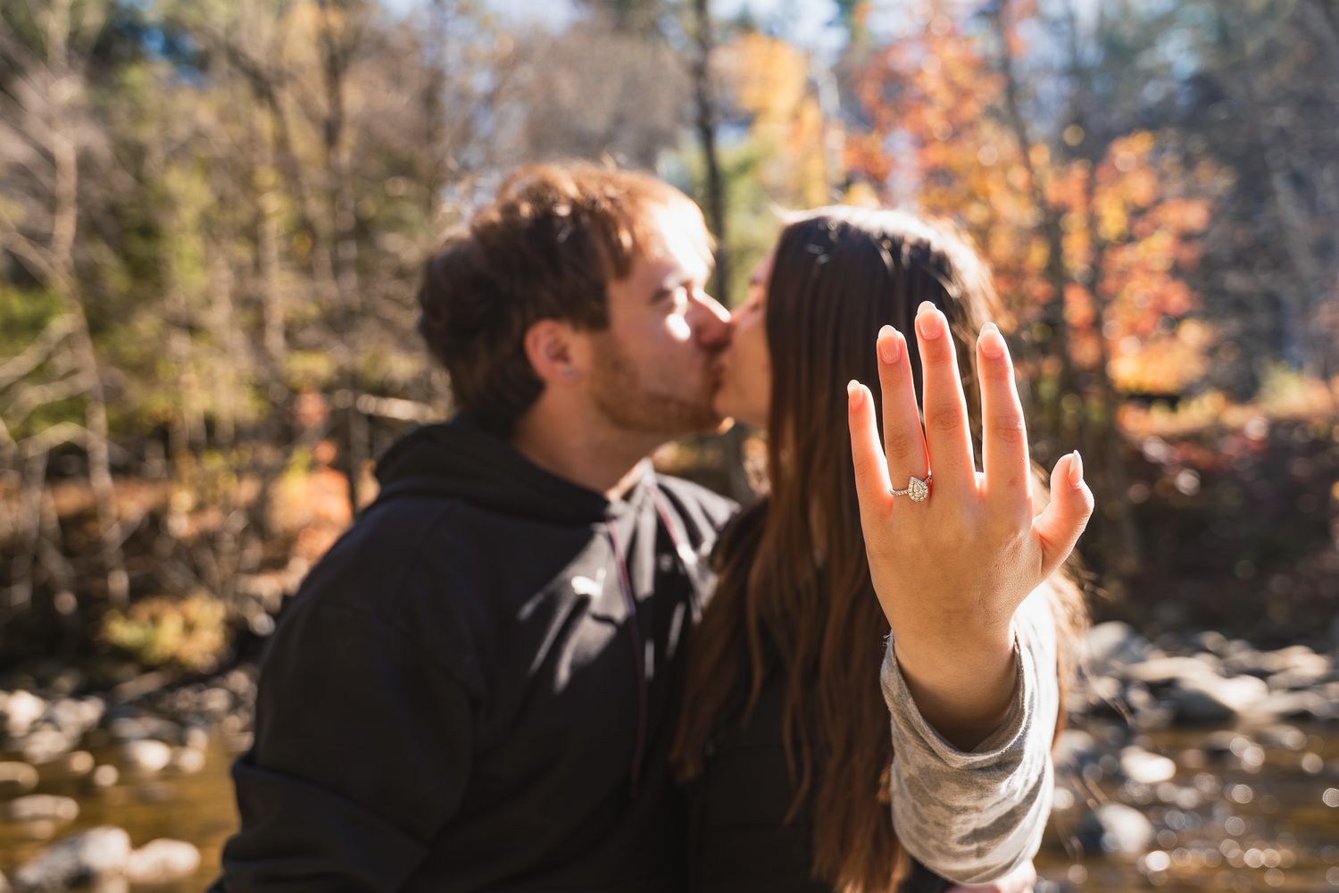 Surprise marriage proposal captured during a romantic engagement photoshoot.
