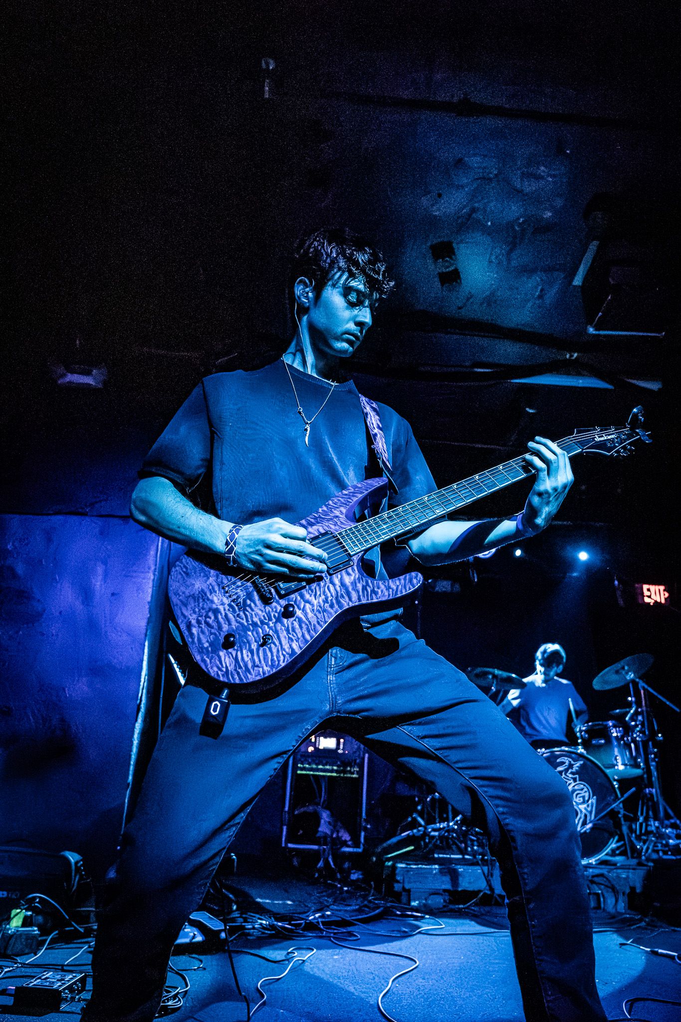 Live concert photography capturing a band performing on stage with dramatic lighting