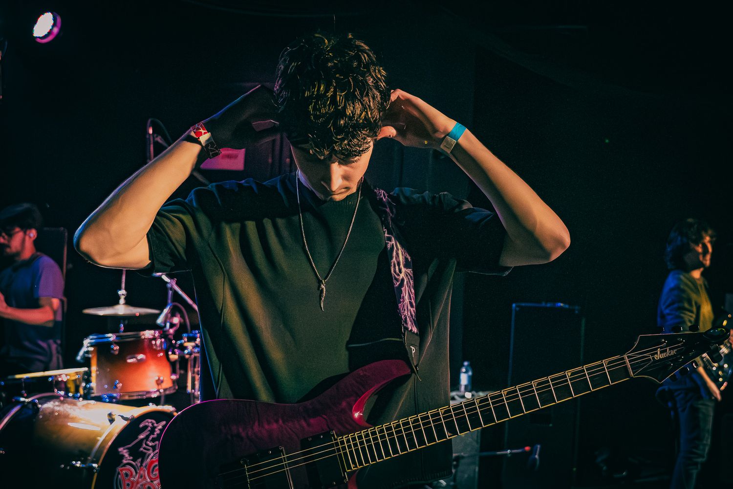 Live concert photography capturing a band performing on stage with dramatic lighting