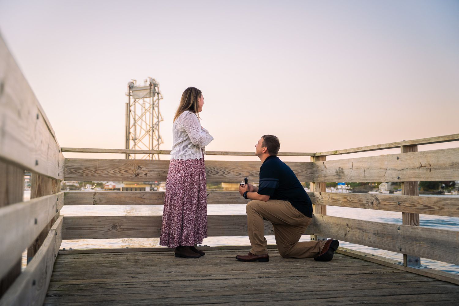 Surprise marriage proposal captured during a romantic engagement photoshoot.