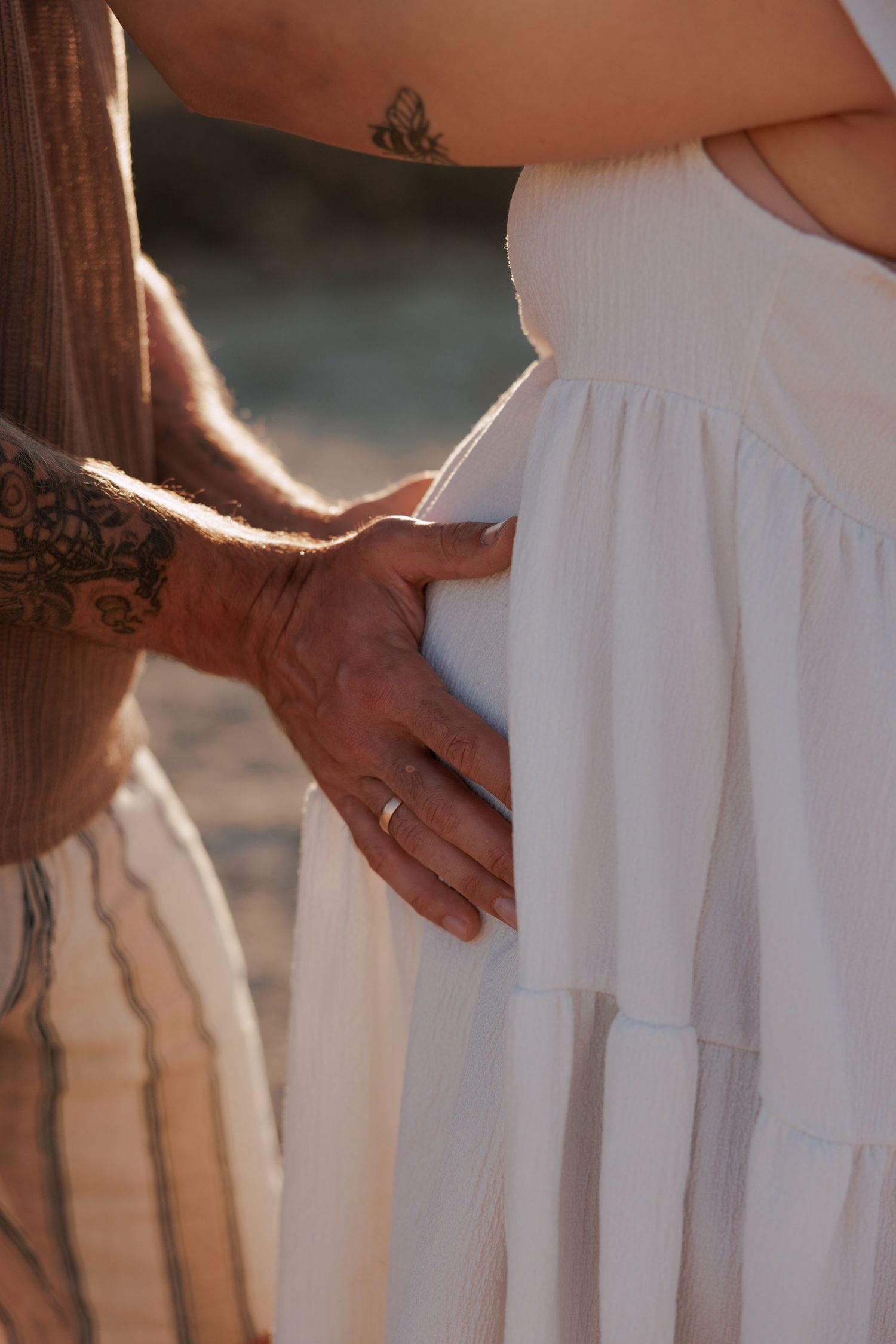 Close-up maternity photo of hands on a baby bump during a Cyprus photoshoot