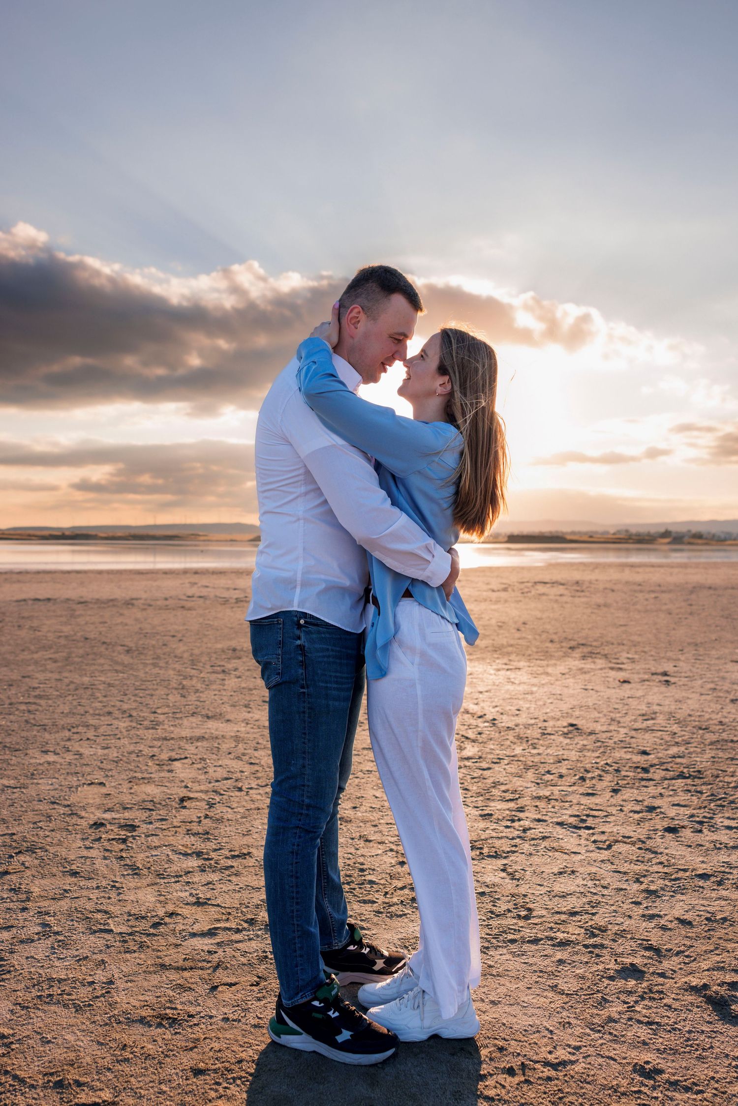 Couple embracing on Larnaca Salt Lake in Cyprus during a romantic photoshoot
