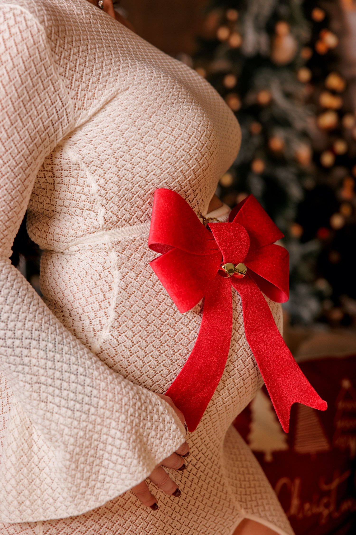Woman in white dress posing indoors during a Christmas portrait photoshoot in Cyprus