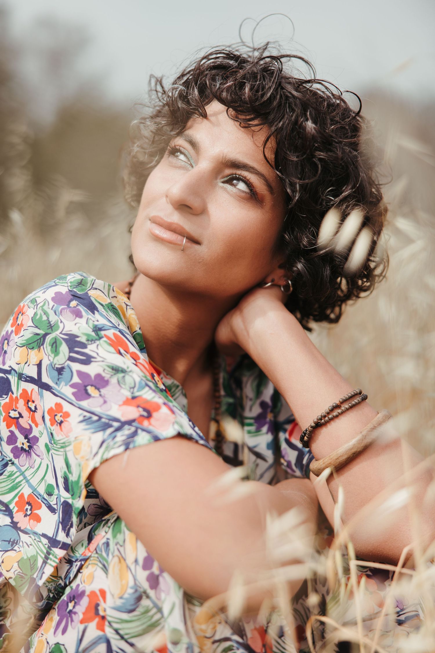 Woman in a colorful floral dress posing outdoors during a bright lifestyle photoshoot in Cyprus