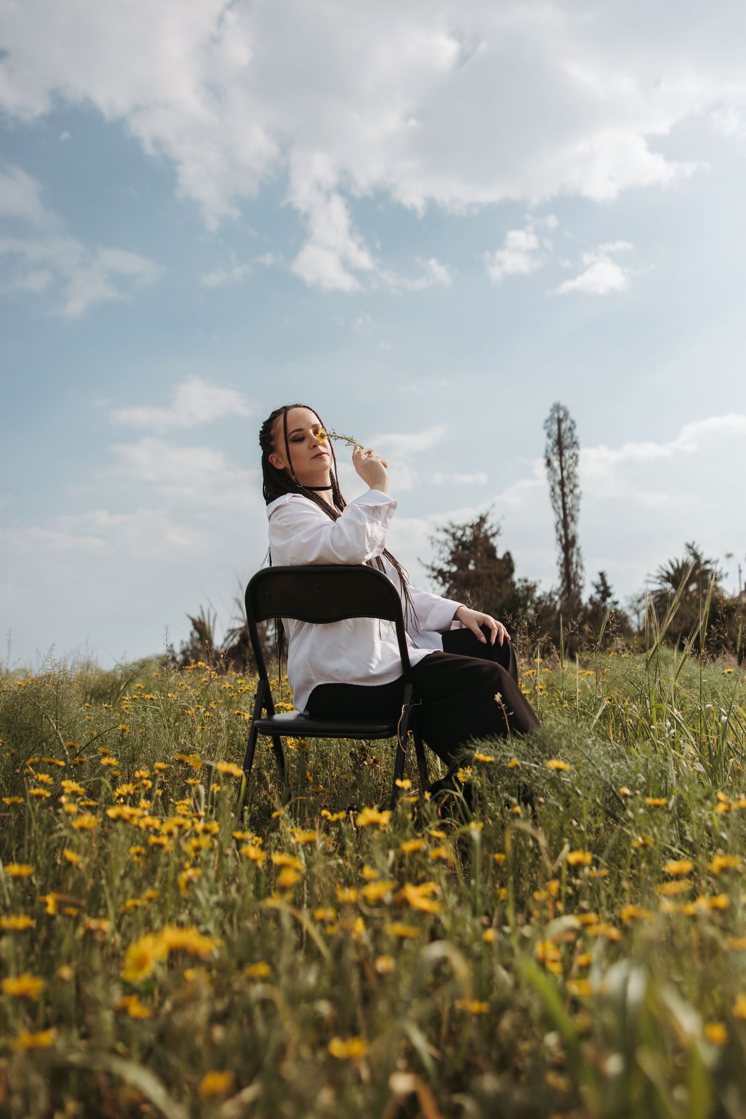 Woman sitting in a flower field during a bright creative photoshoot in Cyprus