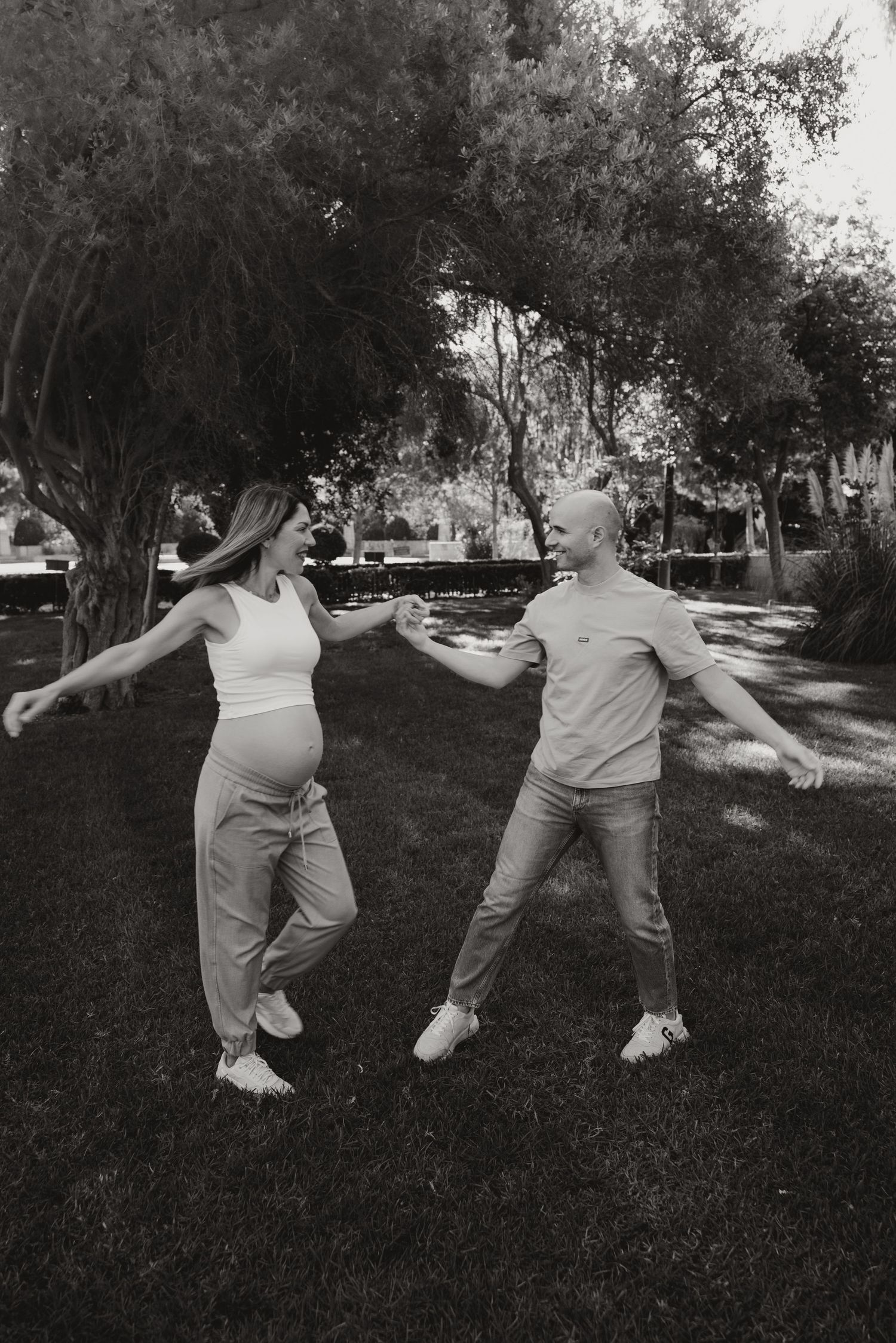 Black and white photo of a couple dancing outdoors during a Cyprus maternity photoshoot