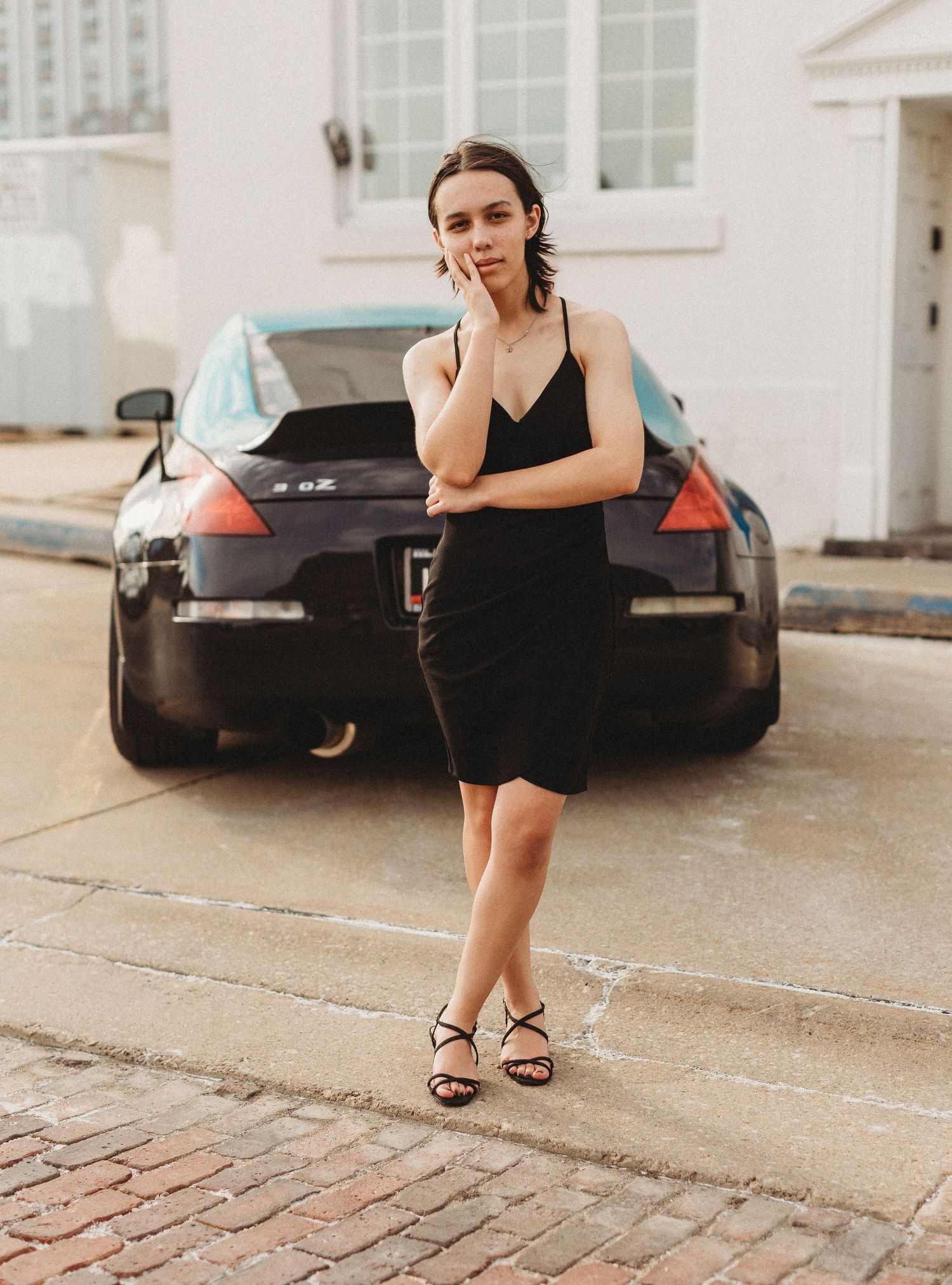 girl standing in front of car