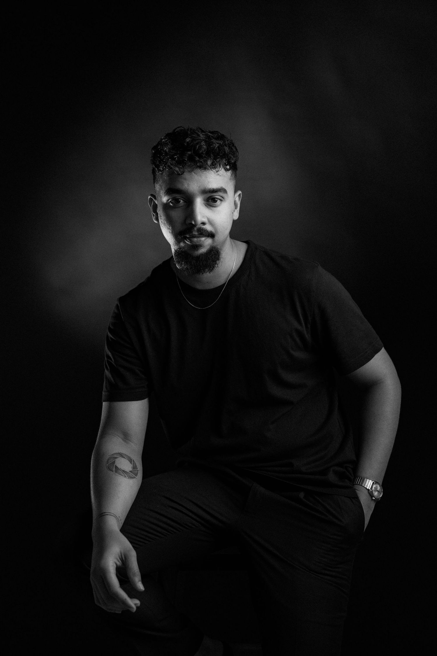 Artistic black and white photography sequence showing motion and movement in dark studio lighting.