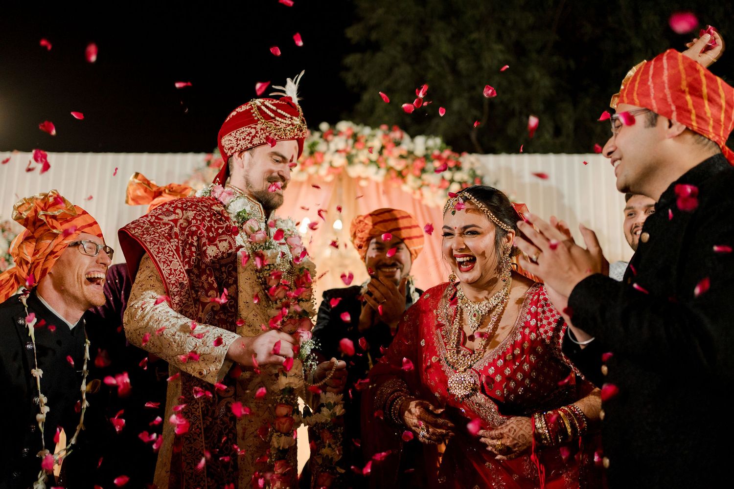 A wedding at Delhi with shower petals on the bride and groom