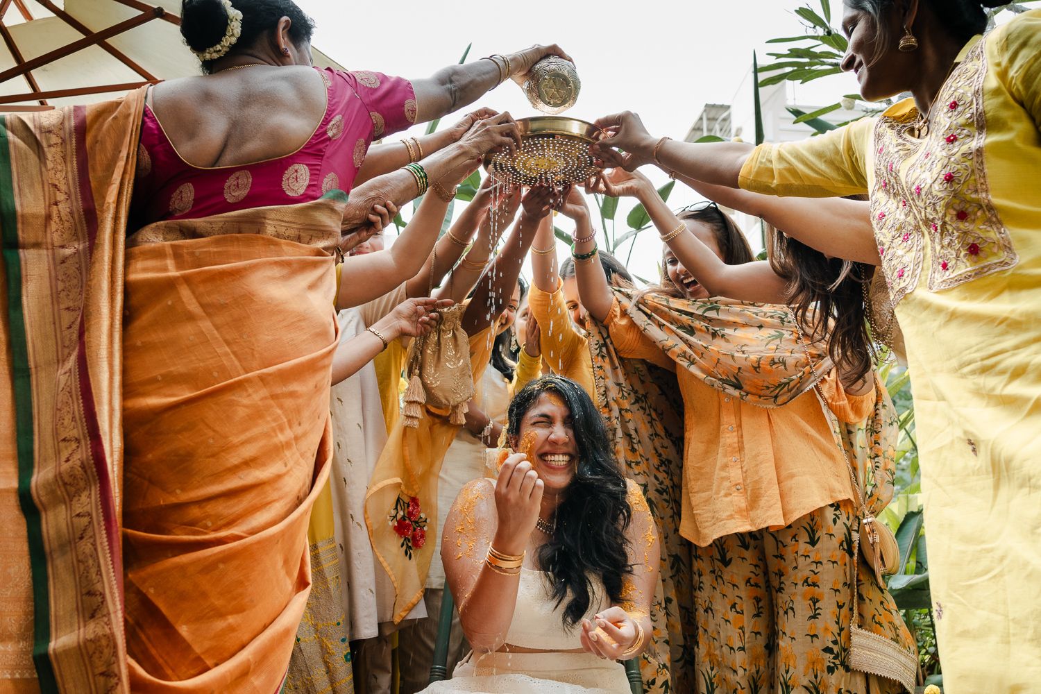 A celebratory moment at a wedding ceremony with people joining hands to create an arch overhead.